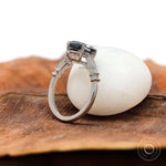 Step cut grey moissanite with round accent diamonds