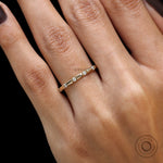 Diamond distance wedding band yellow gold close up