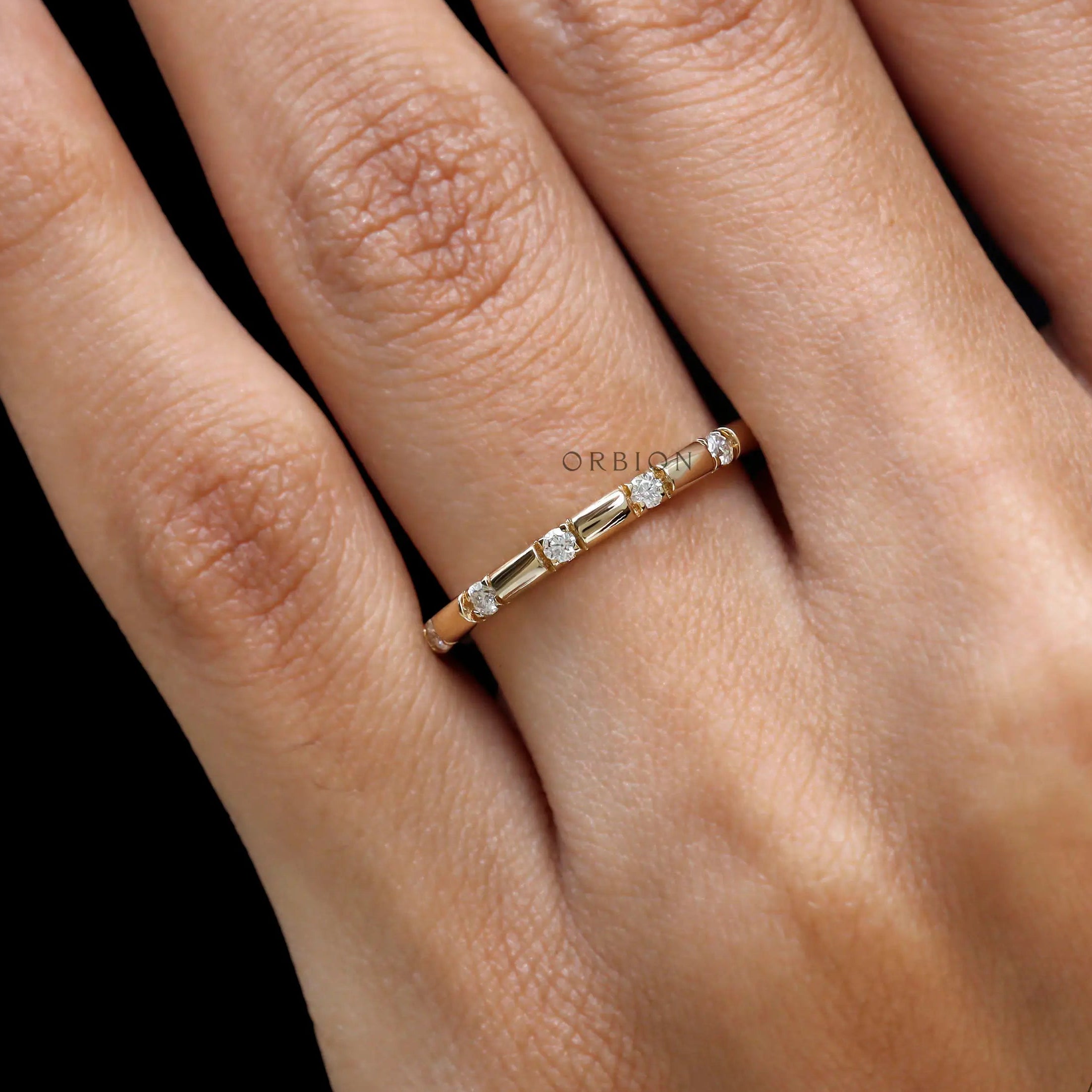 Diamond distance wedding band yellow gold close up