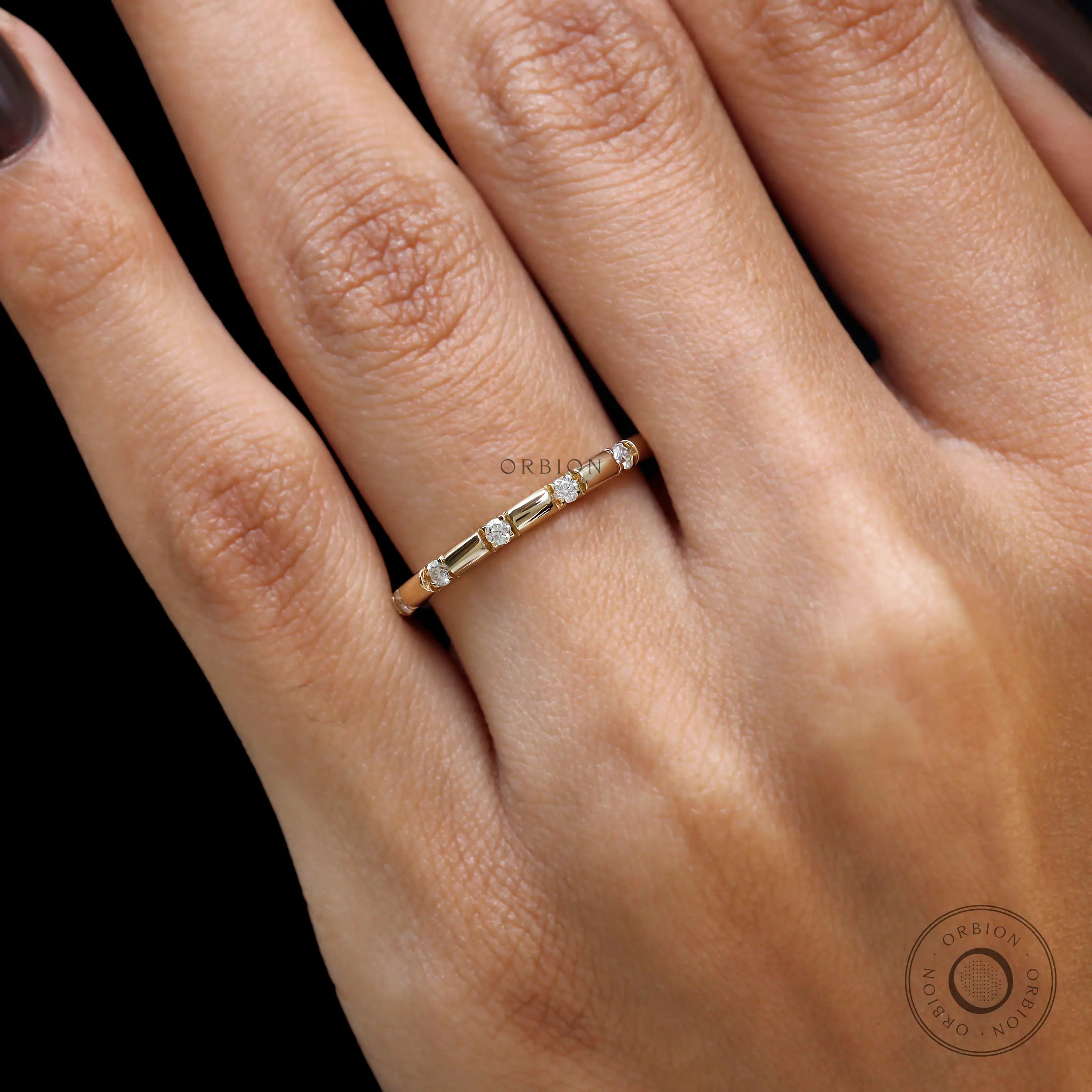 Diamond distance wedding band yellow gold close up