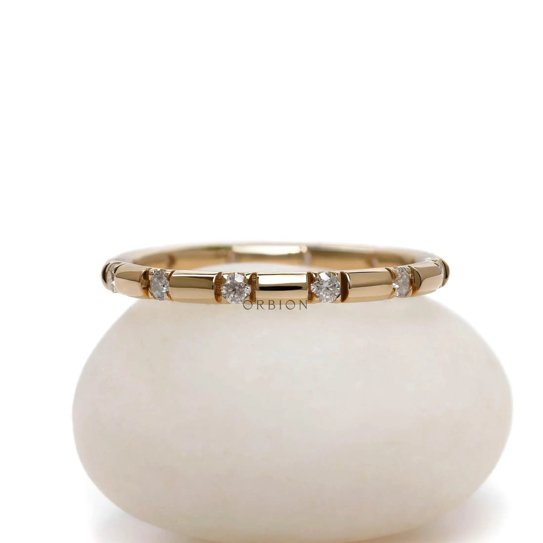 Station style full eternity moissanite wedding band in 14K yellow gold
