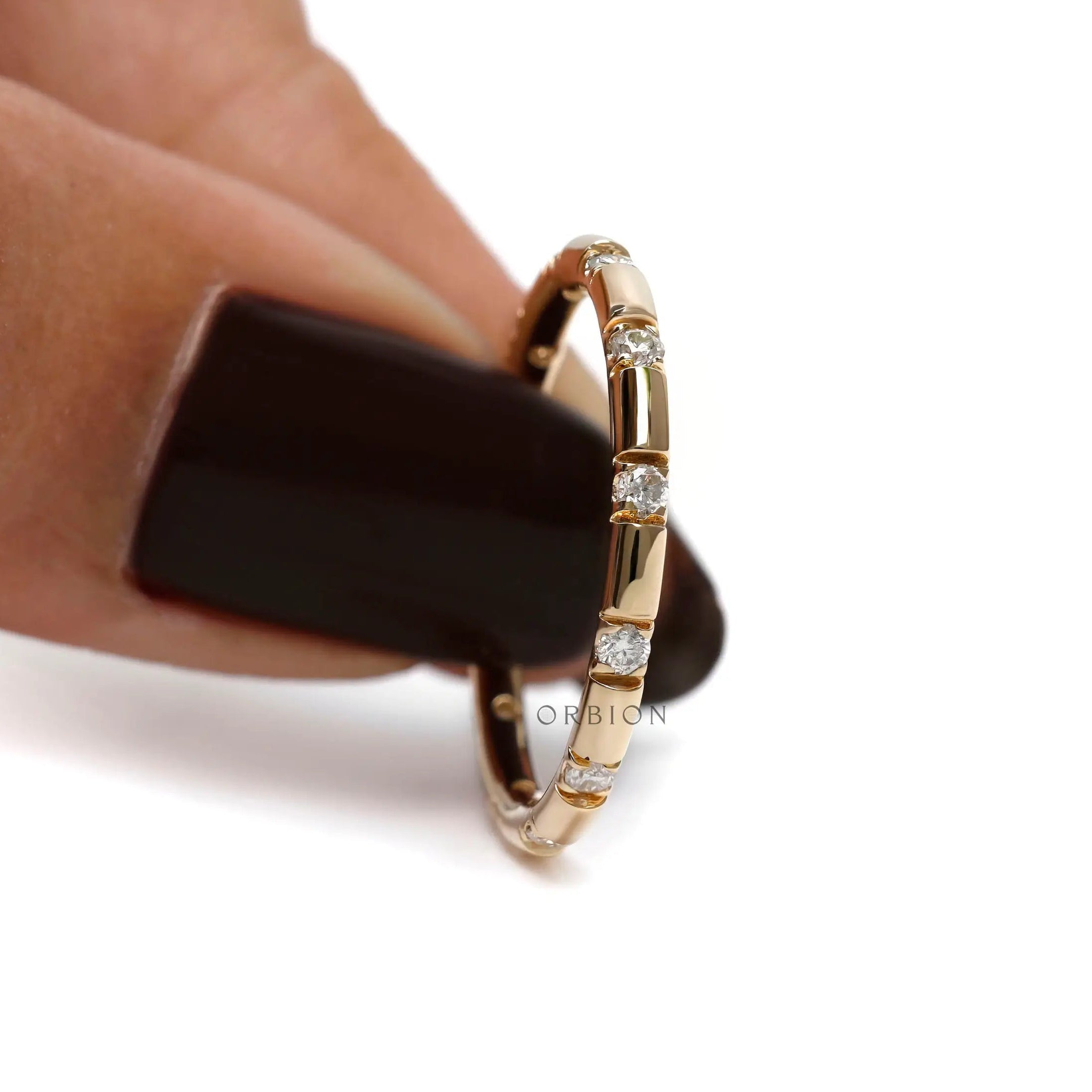 Yellow gold stacking wedding band with evenly spaced stones