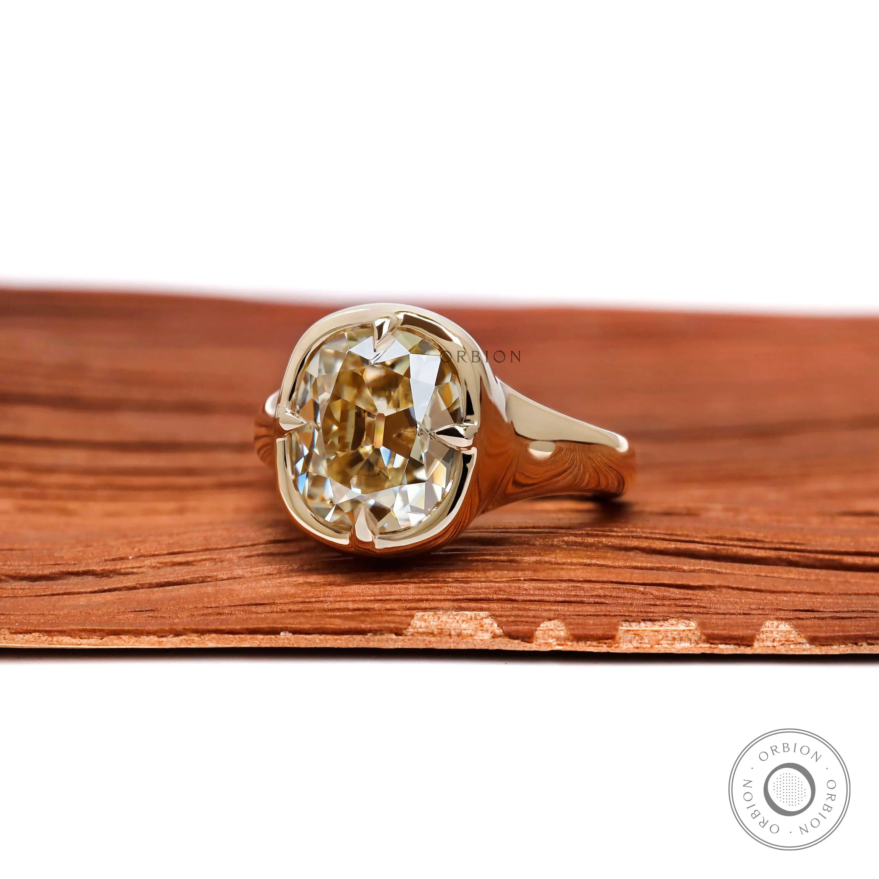 Side profile of bezel set champagne moissanite ring with euro shank