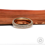 Close up of triple row pave diamond eternity ring