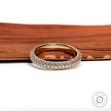 Close up of triple row pave diamond eternity ring