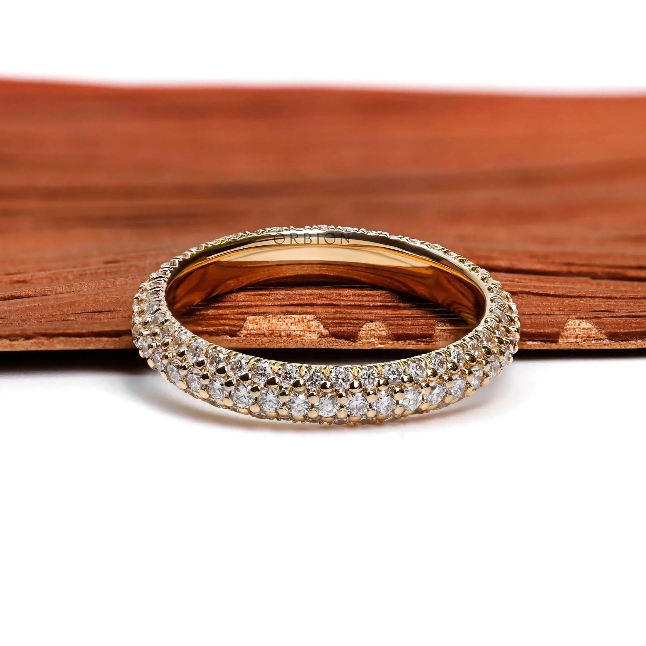 Close up of triple row pave diamond eternity ring