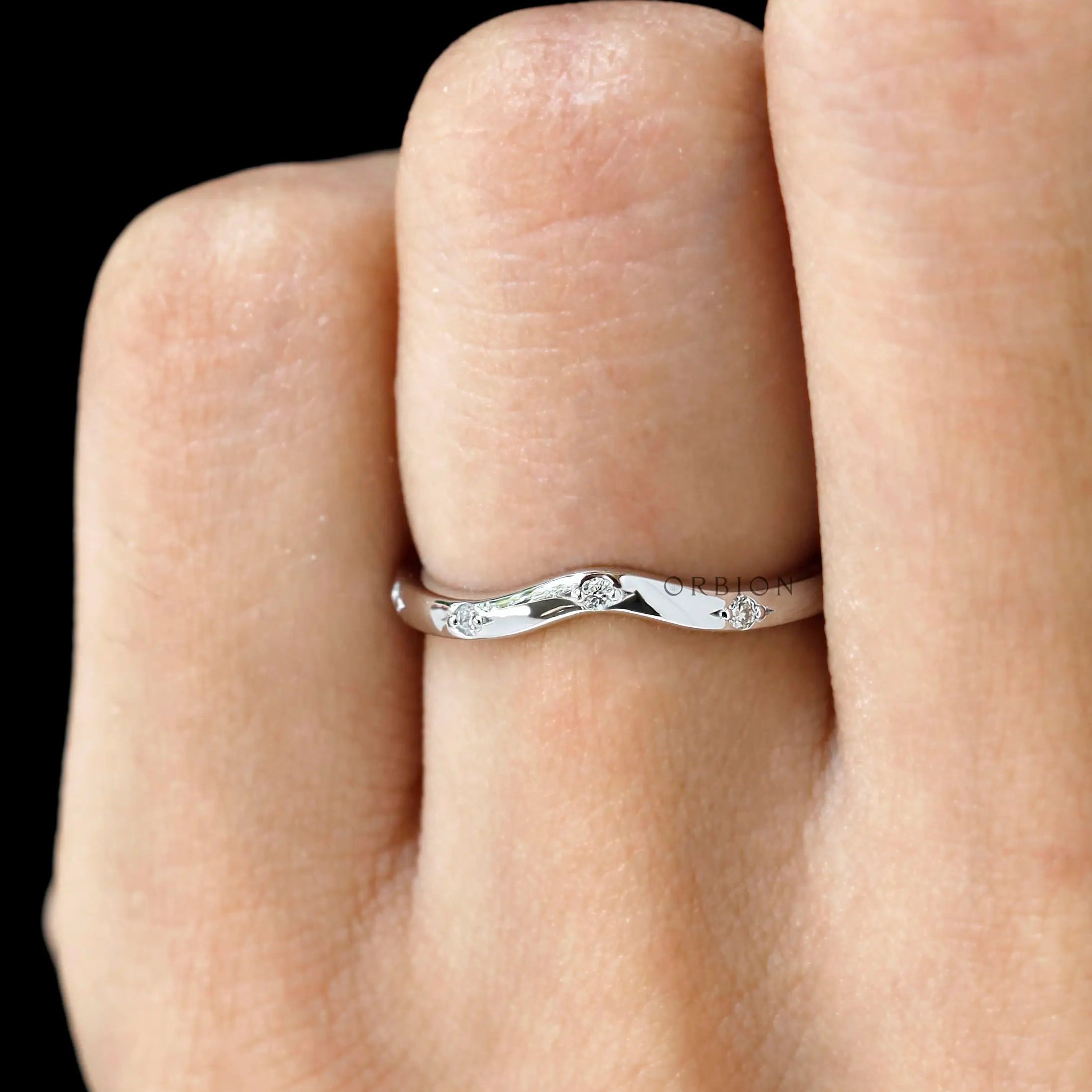 Thin white gold nesting wedding band close up