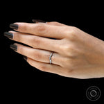 Elegant white gold curved wedding band on finger
