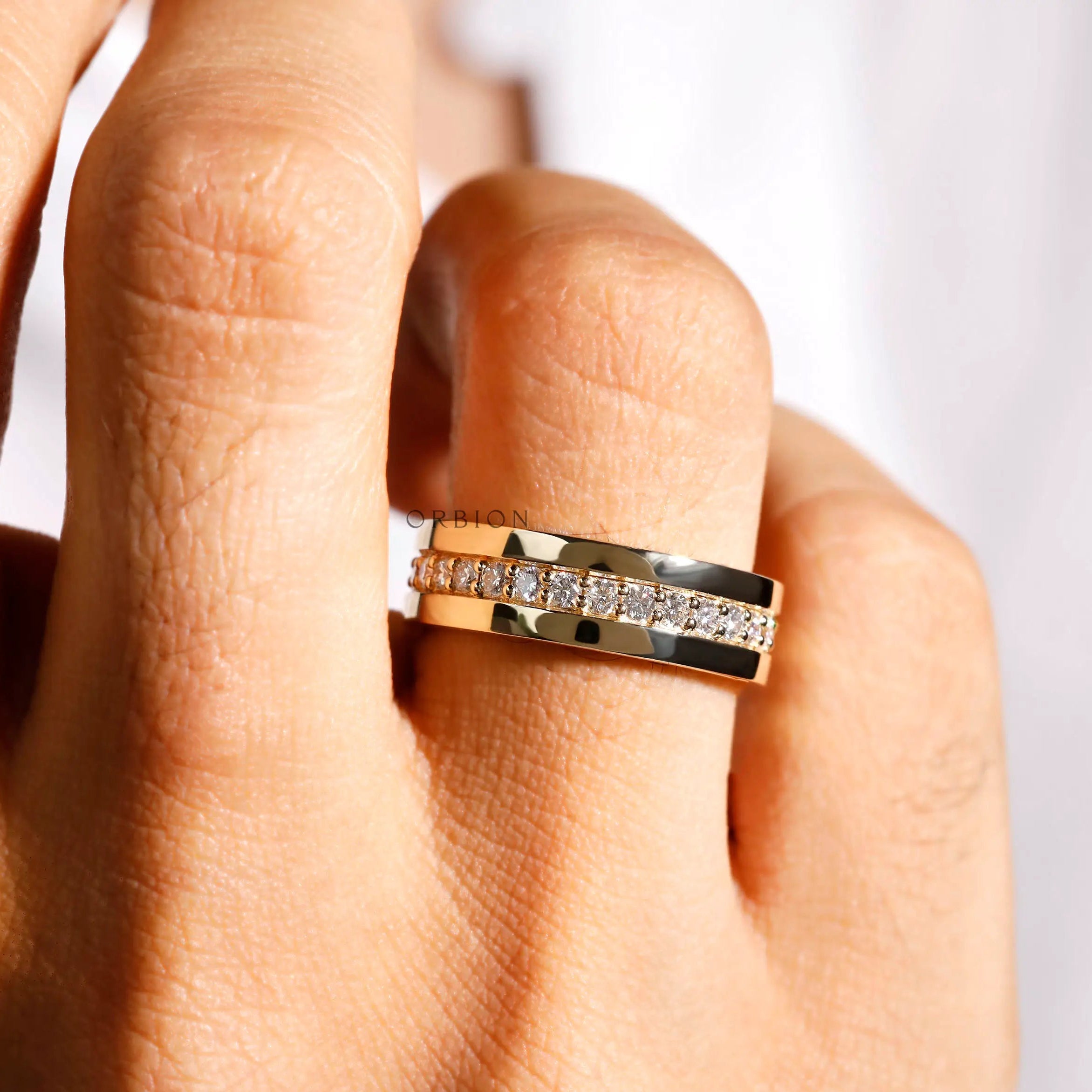 Mens yellow gold lab diamond full eternity wedding band on hand close up