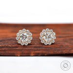 Round halo lab diamond stud earrings in yellow gold close-up