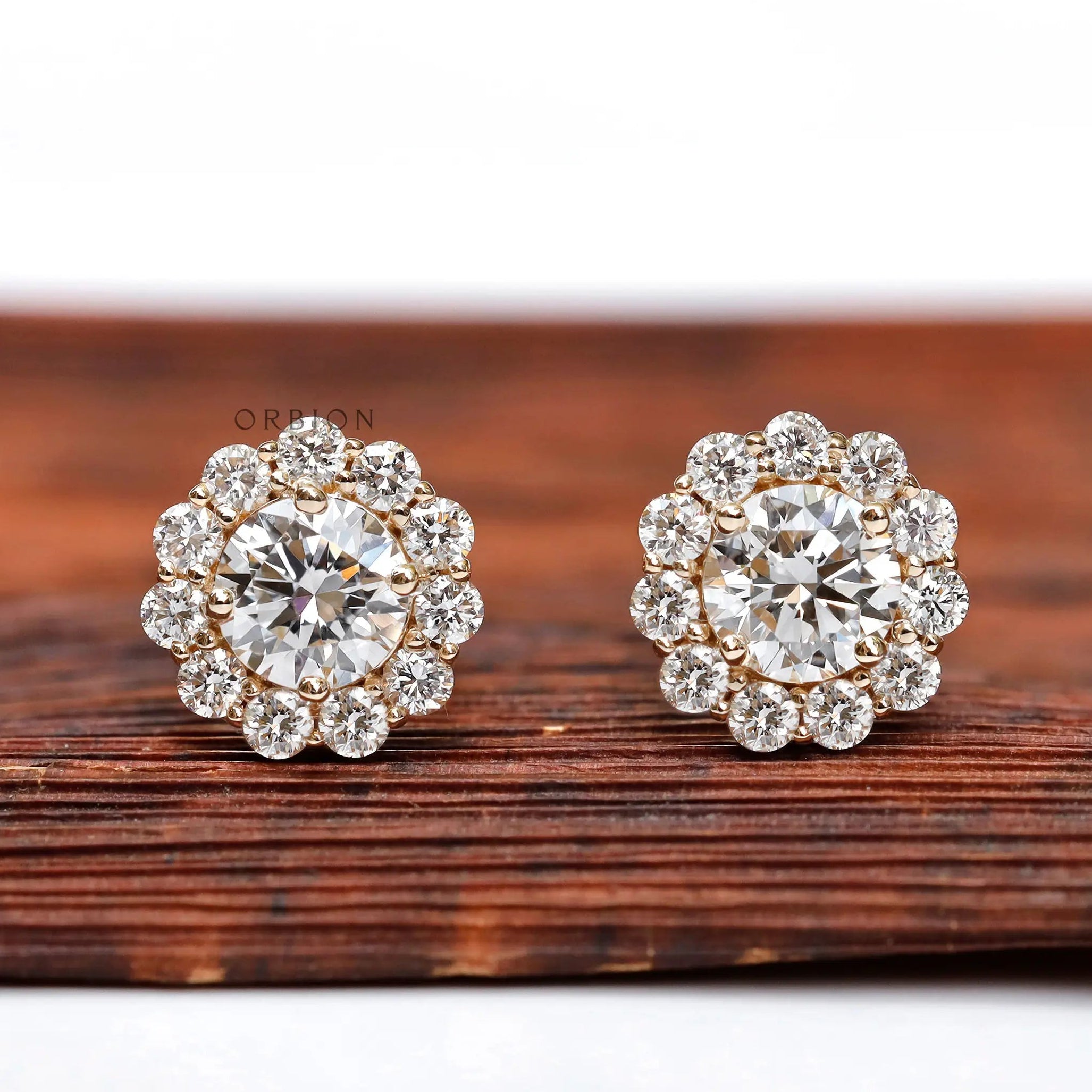 Round halo lab diamond stud earrings in yellow gold close-up