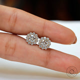 Lab diamond halo studs displayed on finger for size reference