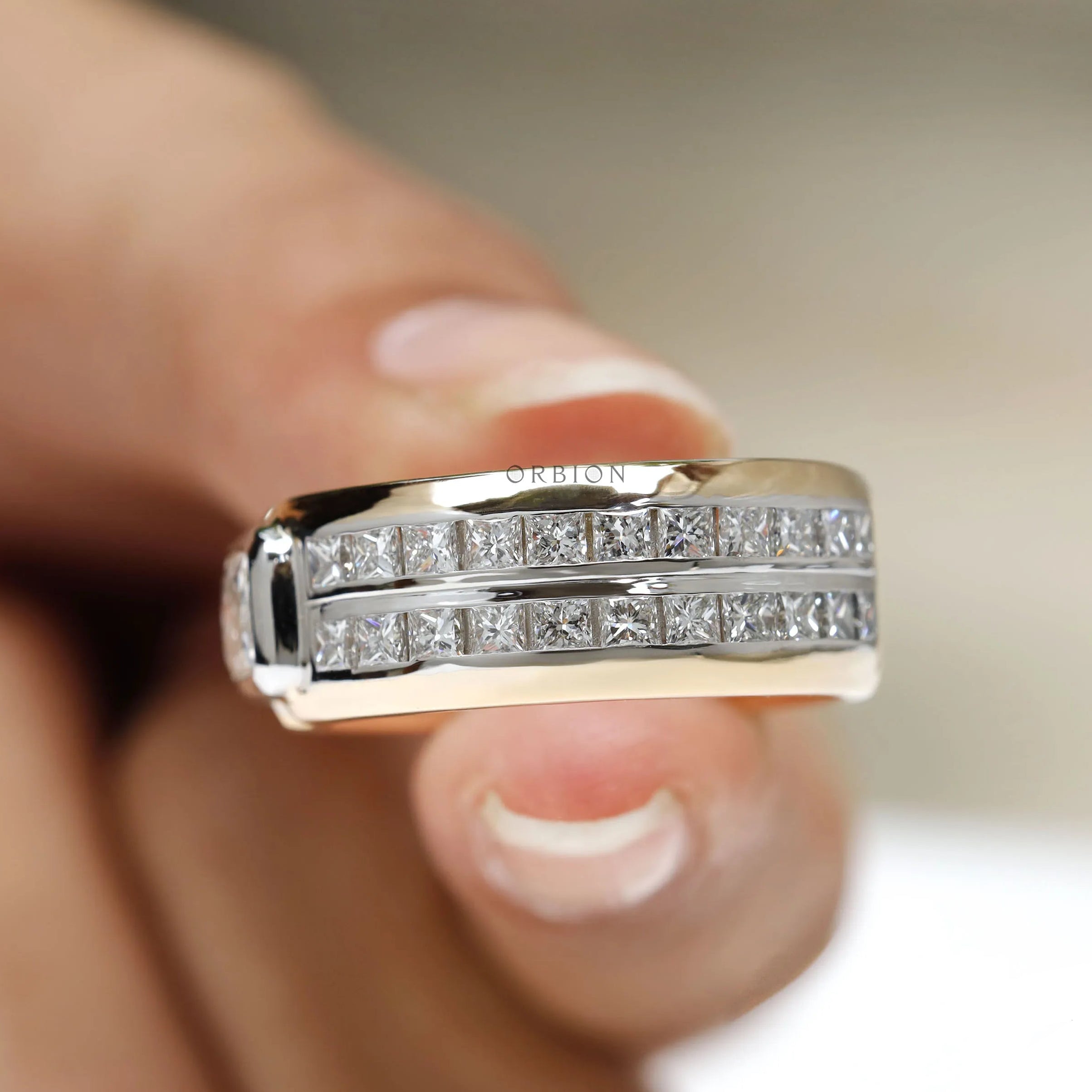 18k Two tone mens diamond band featuring radiant and princess cut stones