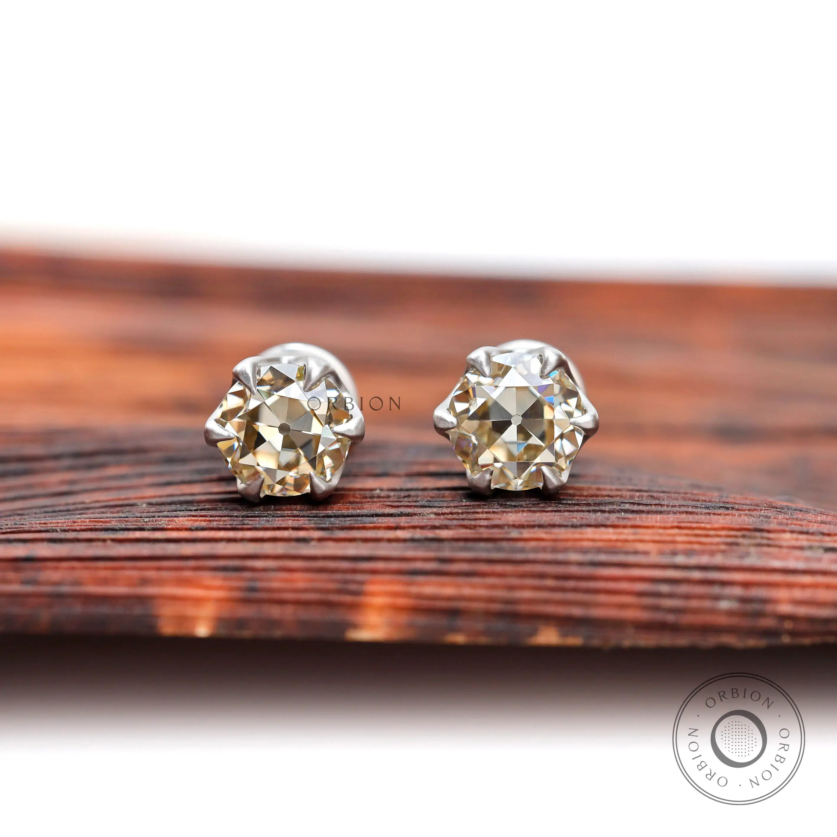 Round champagne moissanite stud earrings in 10K white gold