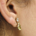 Unique two stone stud earrings with yellow lab diamonds, teardrop silhouette and elegant drop setting