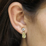 Modern yellow diamond earrings featuring round and pear lab grown diamonds in a delicate gold design