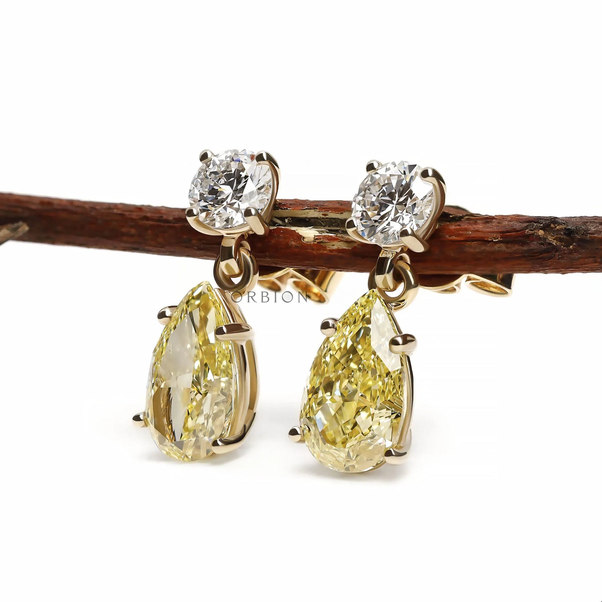10k yellow gold earrings featuring pear and round yellow lab diamonds in elegant two stone drop design