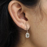 Classic old mine cut moissanite drop earrings in yellow gold with elegant dangling stones and antique styling.