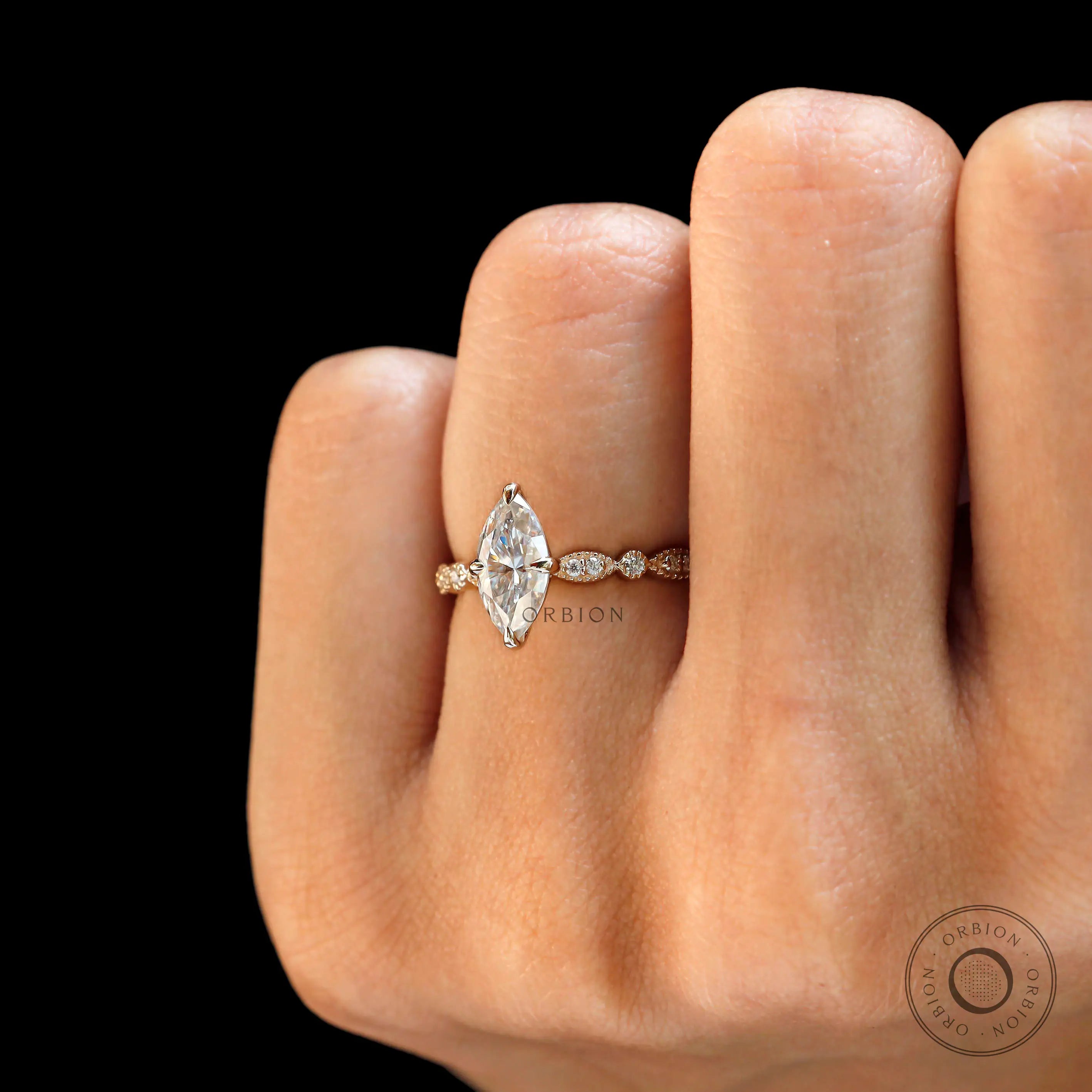 Bridal marquise ring with delicate diamond side stones