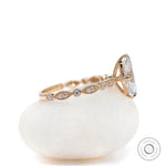 Side view of marquise moissanite ring with accent diamond band