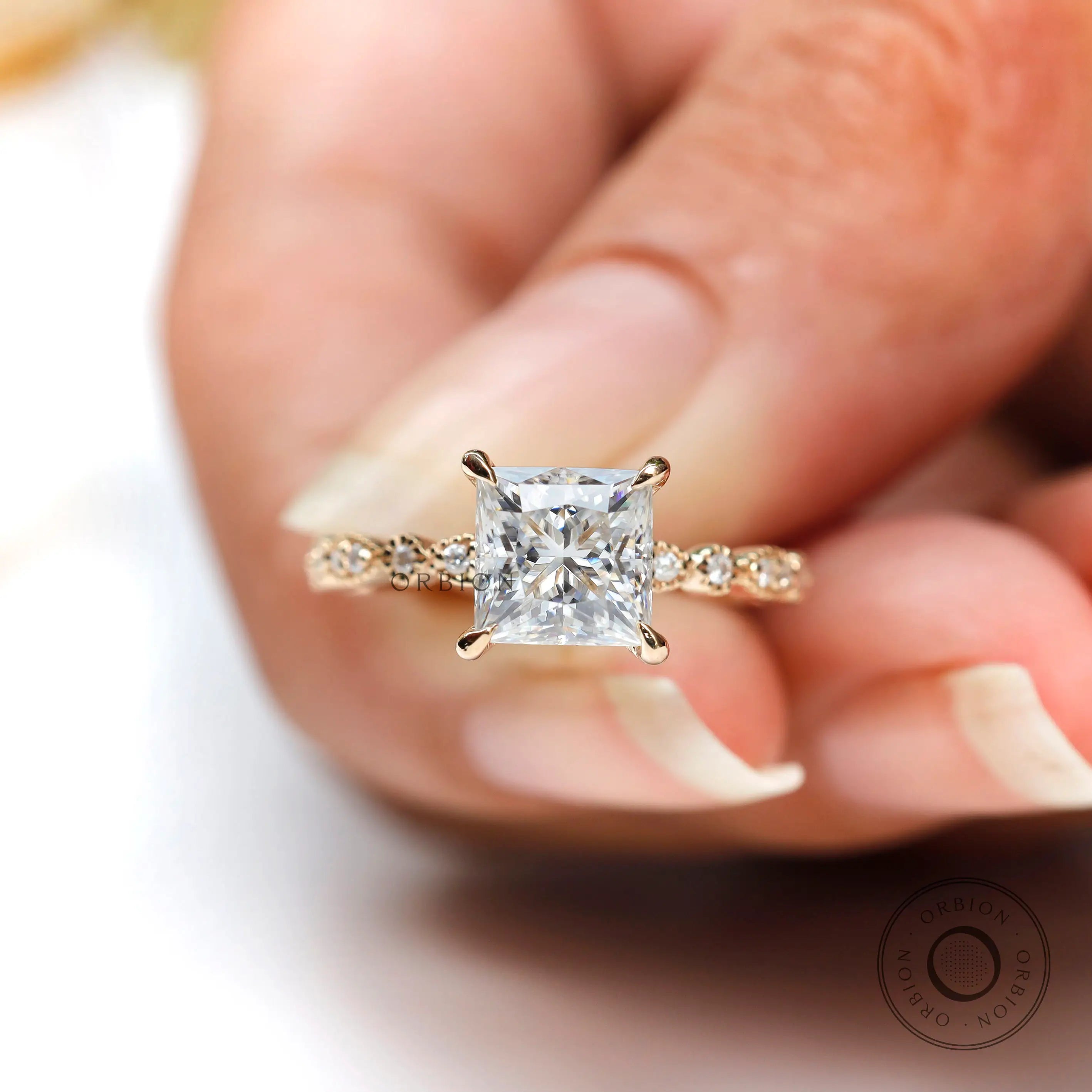 Four prong solitaire princess cut moissanite ring close up