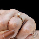 Martini setting emerald solitaire ring close-up