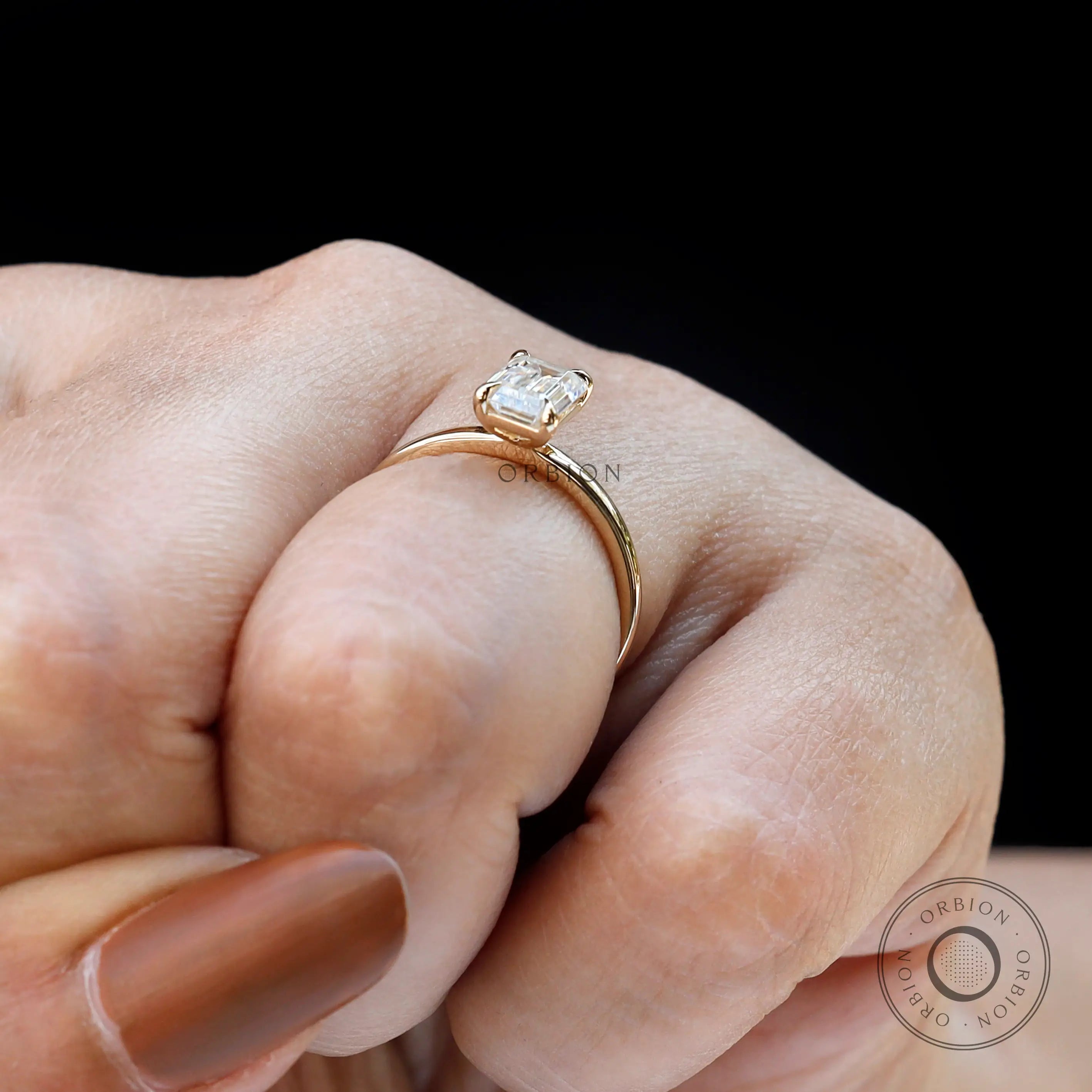 Martini setting emerald solitaire ring close-up