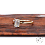 Emerald cut colorless stone ring yellow gold