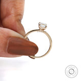 Emerald shaped moissanite ring with polished gold band
