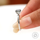 On hand side view emerald cut grey moissanite solitaire