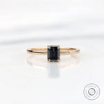 Emerald cut grey moissanite solitaire ring in 14K yellow gold top view