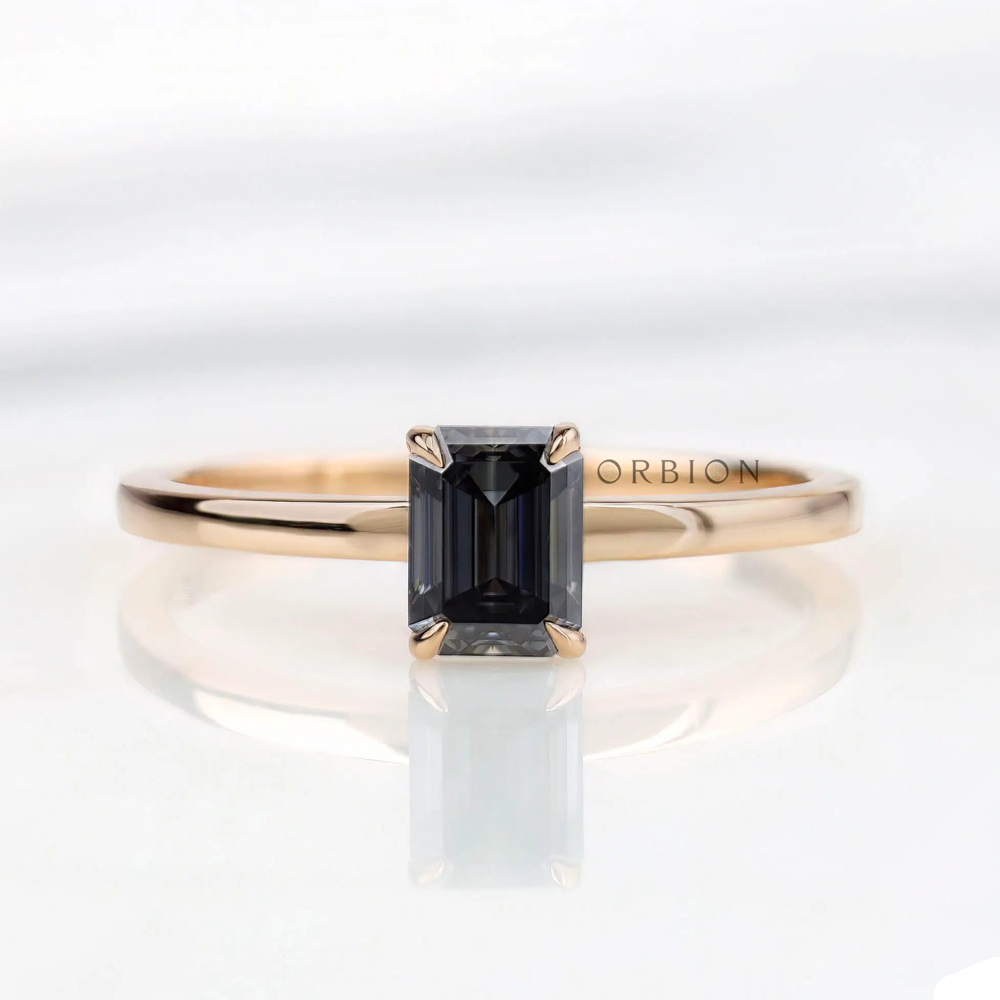 Emerald cut grey moissanite solitaire ring in 14K yellow gold top view