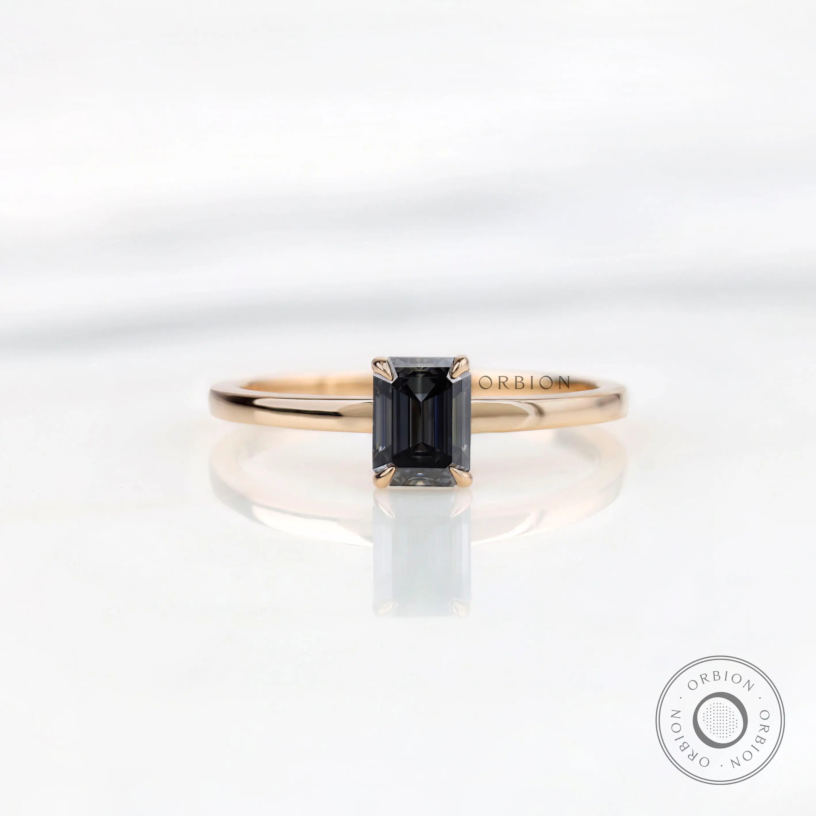 Emerald cut grey moissanite solitaire ring in 14K yellow gold top view