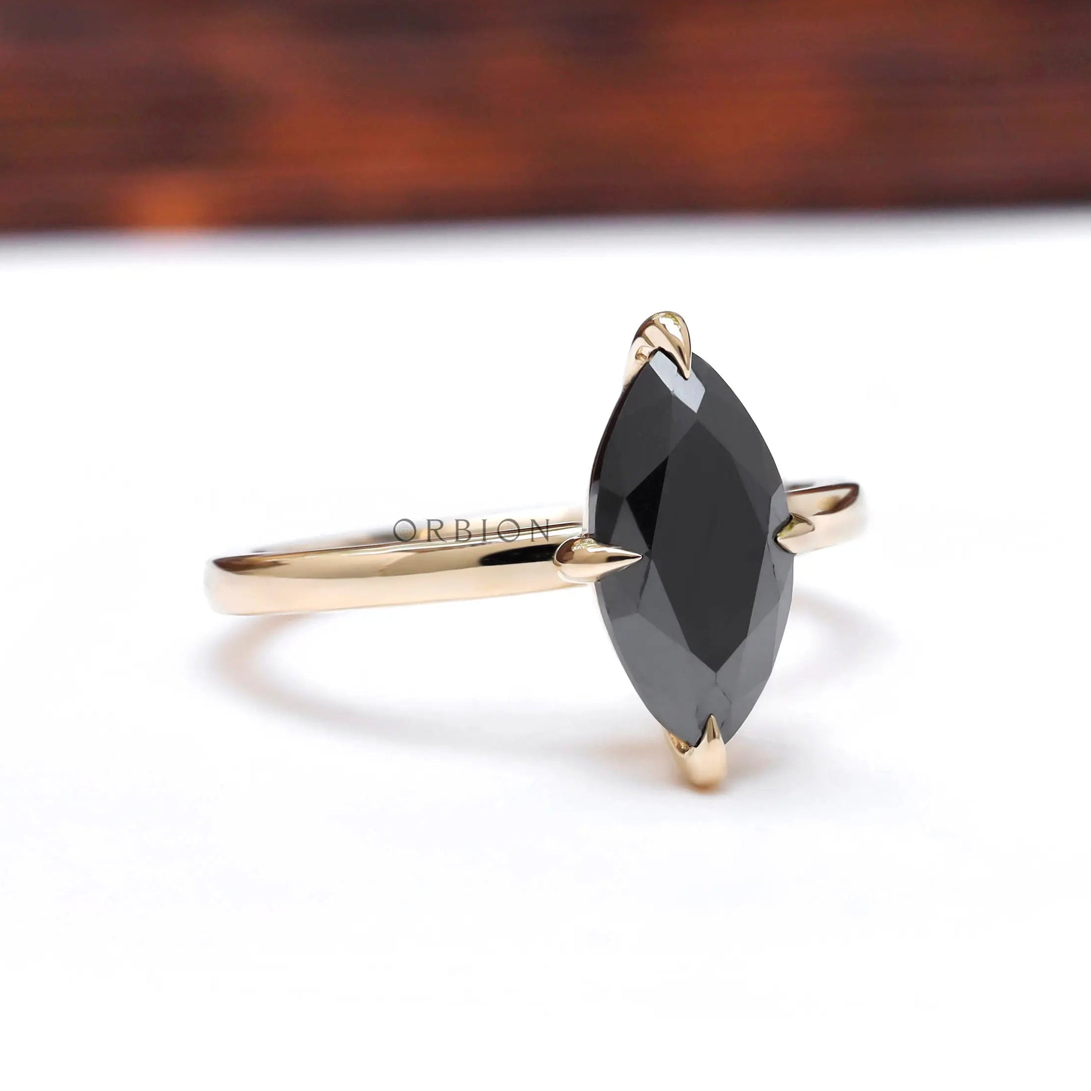 Angled view highlighting marquise black moissanite