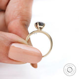 Close-up of brilliant cut marquise black moissanite