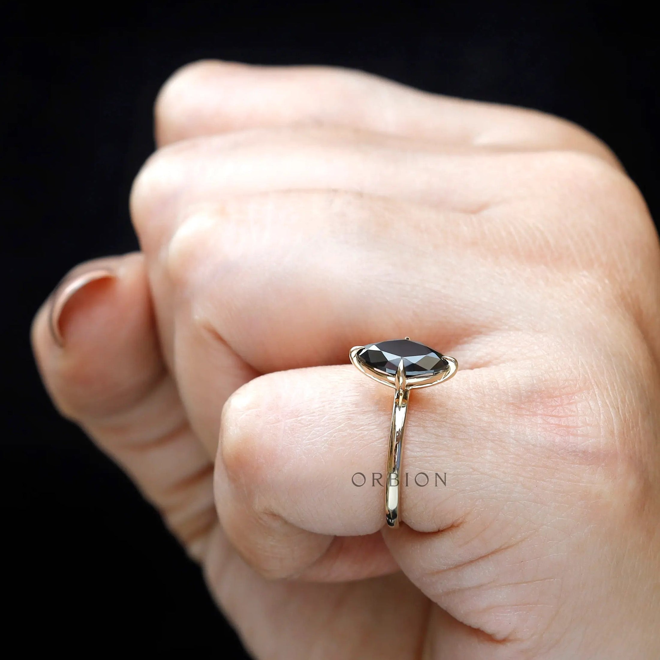 Side view of marquise moissanite ring worn