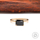 Elegant black gemstone solitaire ring with glossy gold finish