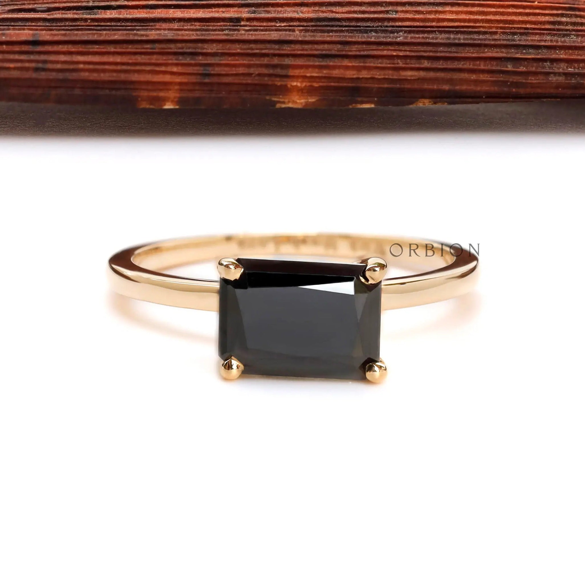 Elegant black gemstone solitaire ring with glossy gold finish