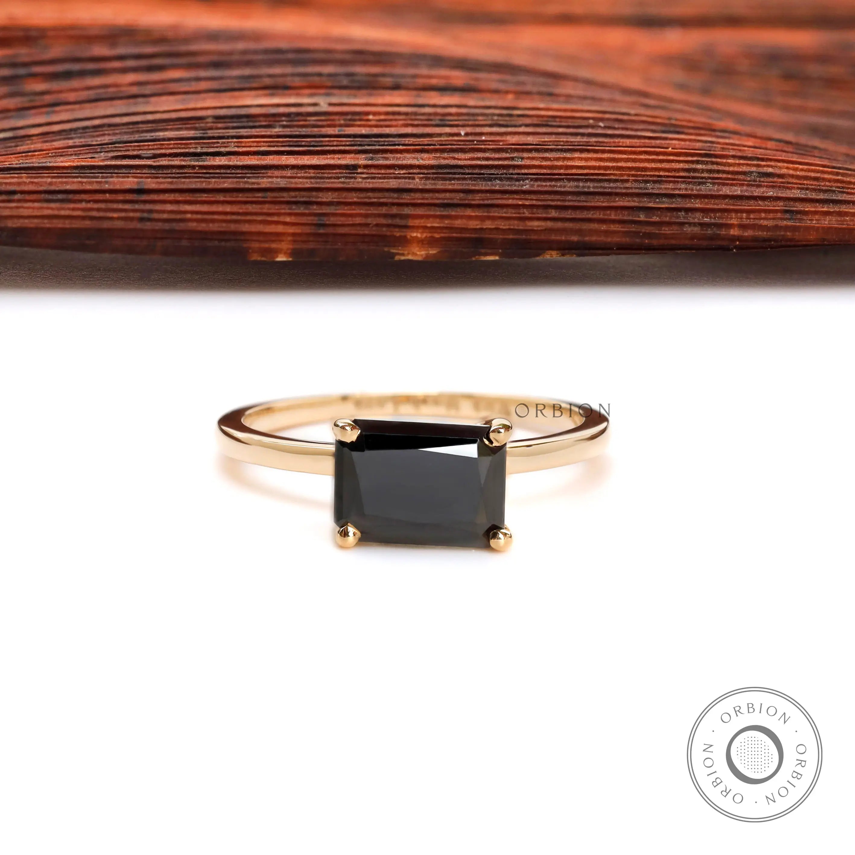Elegant black gemstone solitaire ring with glossy gold finish