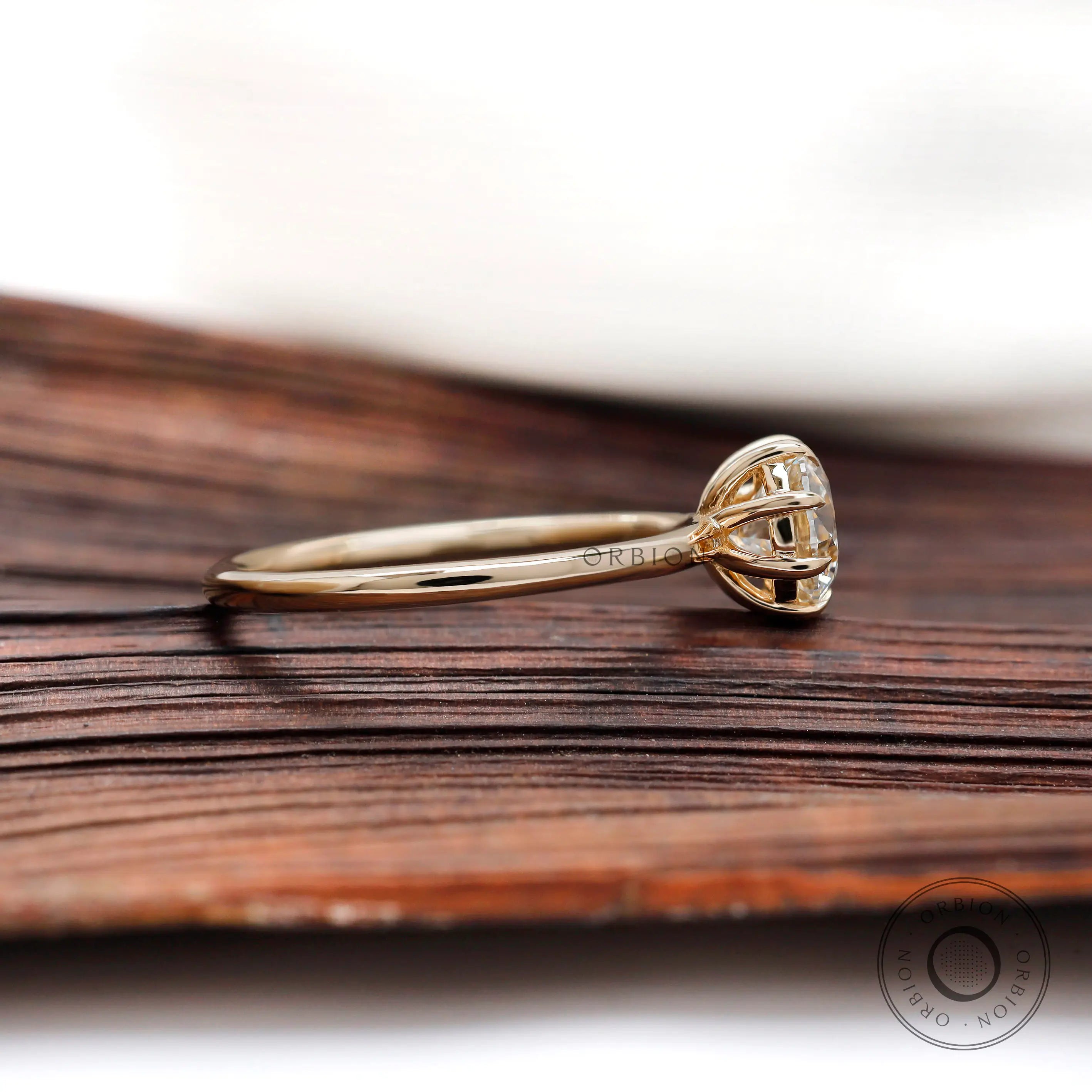 Side profile of round diamond solitaire ring showing prong setting