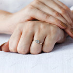 Solitaire diamond ring worn on hand for scale reference