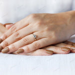 Minimal yellow gold solitaire ring lifestyle image