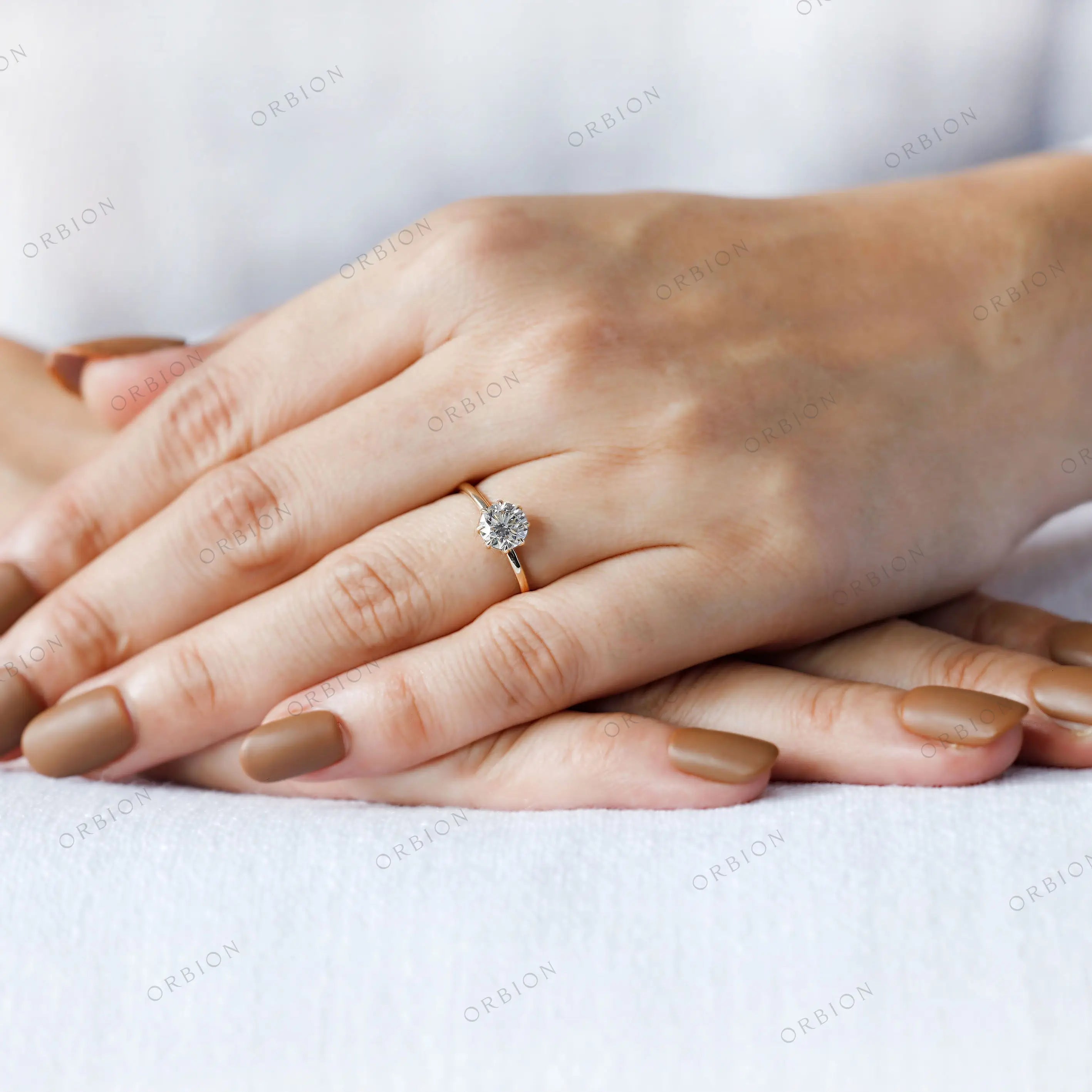 Minimal yellow gold solitaire ring lifestyle image
