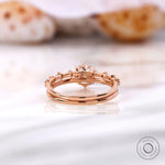 Prong and cathedral shoulder detail of round diamond ring