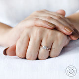 On-hand view of cathedral style round diamond engagement ring
