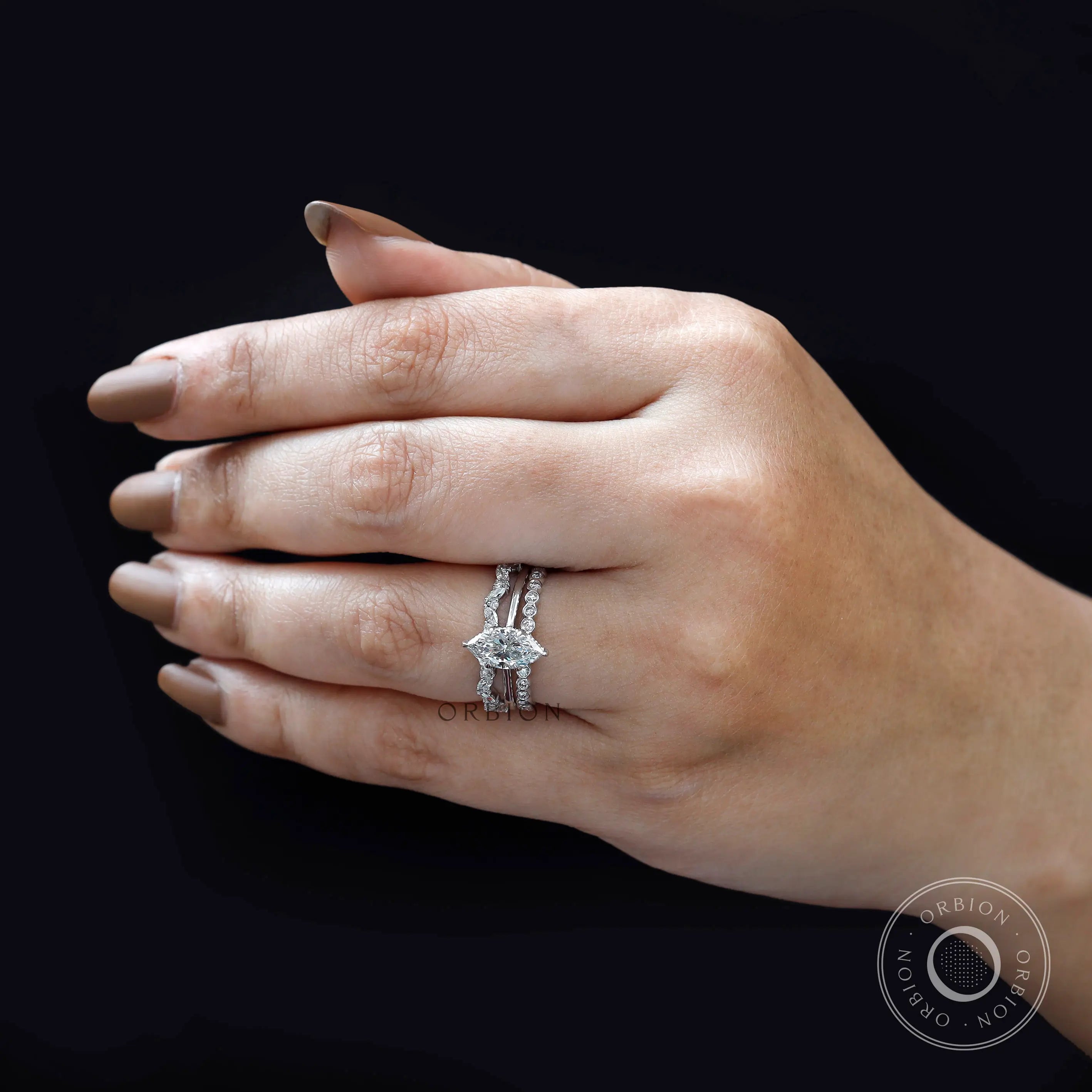 On-hand view of marquise diamond bridal set