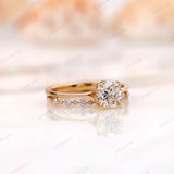 Angled view of round diamond engagement ring with pavé band