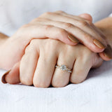 Round brilliant diamond ring worn on hand for scale