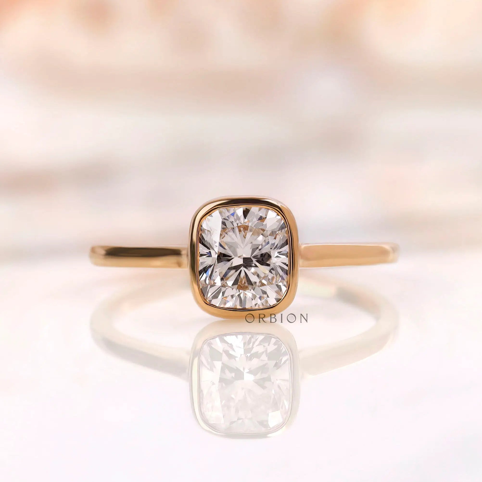 Cushion cut lab grown diamond bezel solitaire ring in 14K yellow gold front view