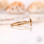 Side profile of cushion diamond bezel ring with tapered yellow gold band